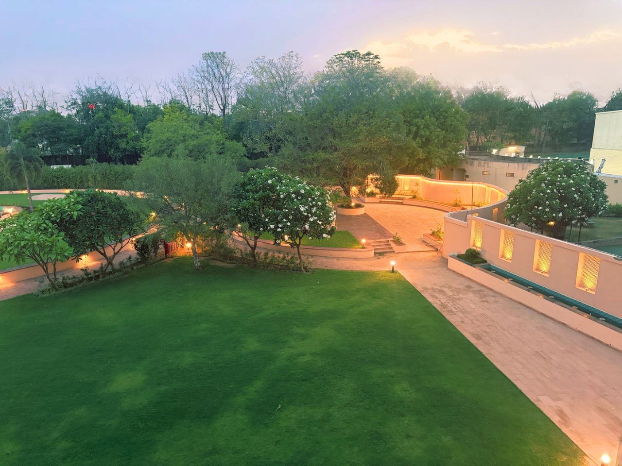 Garden pathway with evening lighting at Vankamal Resort, Jaipur