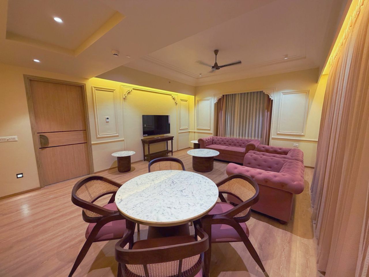 Hotel room living area with dining table at Vankamal Resort, Jaipur