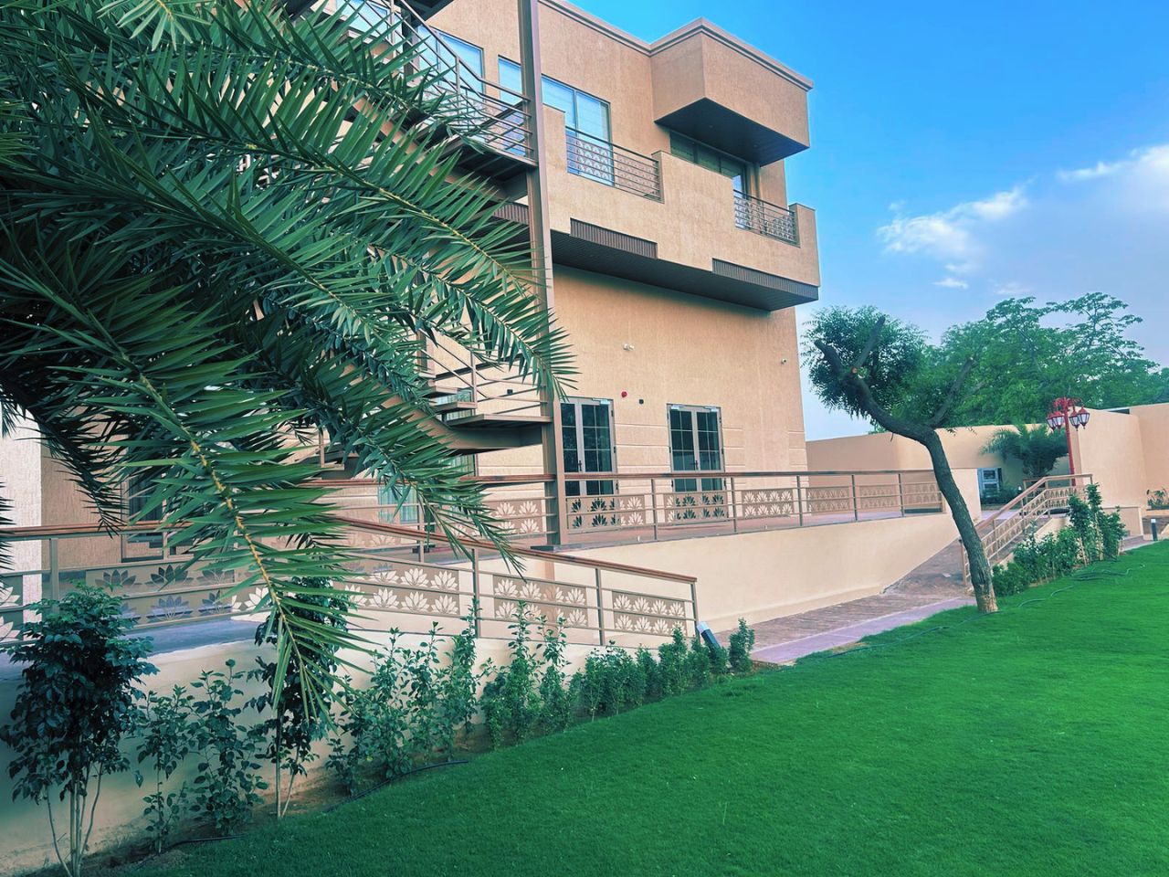Vankamal resort building with palm trees, Jaipur
